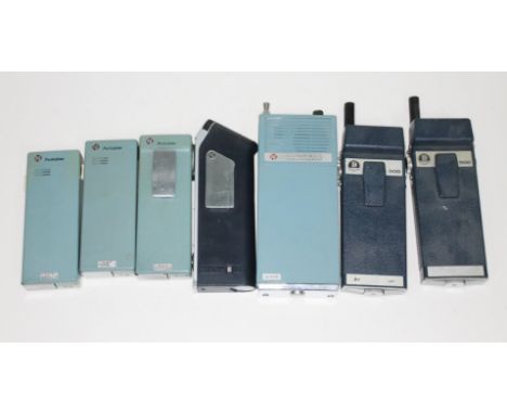 A group of seven vintage walkie talkies comprising four PYE Pocketfone, a PYE Compact Radiotelephone and two Burndept 500.  
