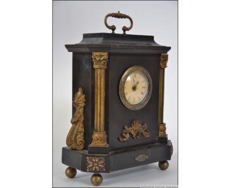 An ebonised early 20th century mantel bracket clock with gilded embellished case and plaque dated 1814. Measures: 30cms high.