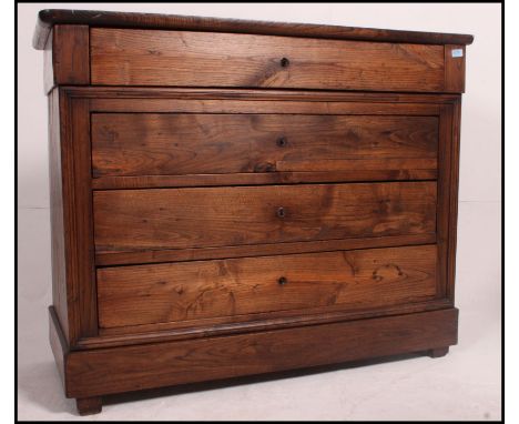 A 19th century French chestnut commode chest of drawers having a central bank of blind fronted drawers with flared top above.