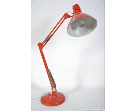A retro 1001 anglepoise style desk top lamp in original orange paint having an applied 1001 label to the base and raised on a