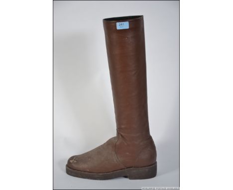 A vintage early 20th century stick stand in the form of a gentlemans riding boot of brown leather. Weight and lined to stand 