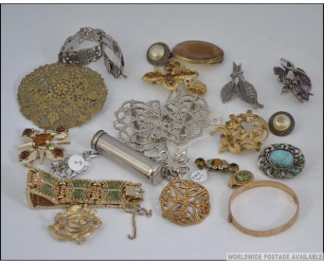 A collection of vintage costume jewellery to include a rolled gold bangle, exquisite brooch, nurses buckles, white metal buck