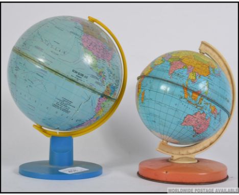2 vintage tin plate globes dating to the mid century in the manner of Chad Valley. Measures 20cm H