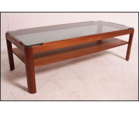 A vintage mid century teak coffee table with smoked glass top , and under shelf , MEYER.  Measures: 112cm x 48cm.