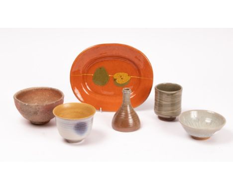 Six items of studio pottery to include a Paul Dennis bowl, a hakeme glaze vase, Winchcombe pottery and an oval apple decorate