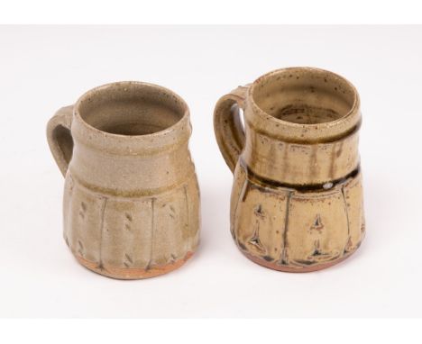 Jim Malone (born 1946) two green stoneware mugs, one in an ash drip glaze, the other in a cracked celadon drip glaze and with