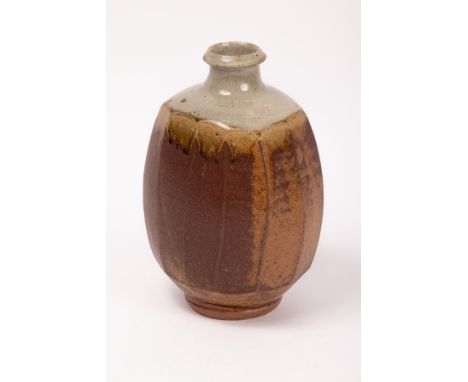 Phil Rogers (1951-2020) a stoneware cut sided bottle vase with a light green dipped neck with darker green drips from the sho