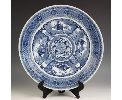 A Chinese porcelain blue and white charger, 19th century, the shallow circular charger decorated with a central peony medalli