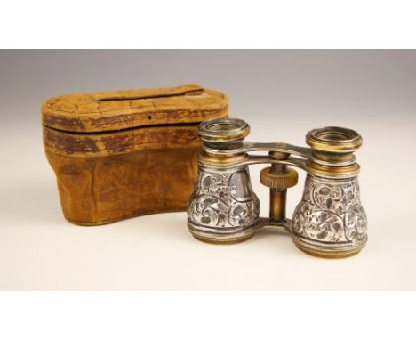 A pair of Victorian silver mounted opera glasses, 'EL' Birmingham 1882, the floriate embossed glasses, 6.5cm high, within a f