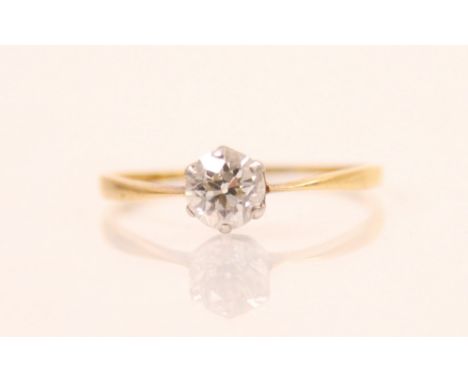 An Edwardian diamond solitaire ring, the old cut diamond in white metal six claw setting, leading to plain polished yellow me