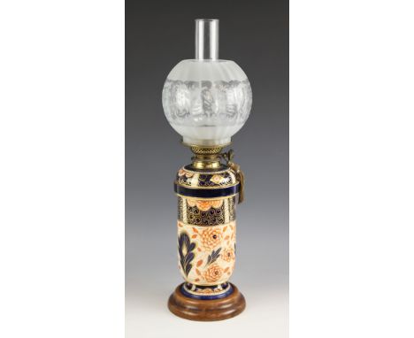 A Royal Crown Derby style oil lamp, 20th century, the Young's Duplex burner set to a porcelain footed cylindrical body decora