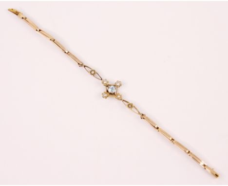 An Edwardian style aquamarine and seed pearl bracelet, the central openwork panel with round cut aquamarine and seed pearl su