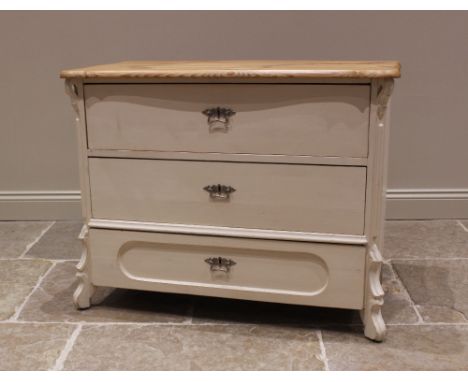 A painted pine commode/chest of drawers, late 20th century, the serpentine top over three long drawers, flanked by canted cor