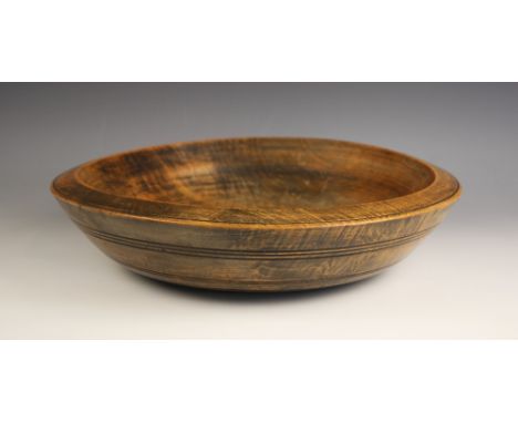 A sycamore bowl of shallow form, late 19th century, with incised key line and banded detail, 41cm diameter (at fault)Conditio