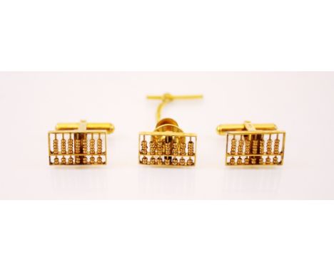 A pair of gold coloured cufflinks, each designed as abacus, stamped 14k, with a similar stud with safety chain, gross weight 