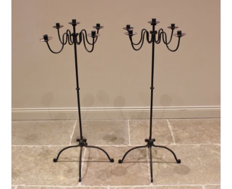 A pair of wrought iron freestanding candelabra, 20th century, each with four 'S' shaped arms upon a plain pole extending to d