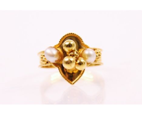 A cultured pearl and yellow metal ring, the flat pear shaped head set with two round cultured pearls and three articulated ye