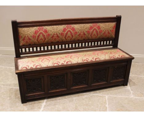 An upholstered oak box settle, stamped Gillows, Lancaster, late 19th/early 20th century, the padded back rest with a turned s