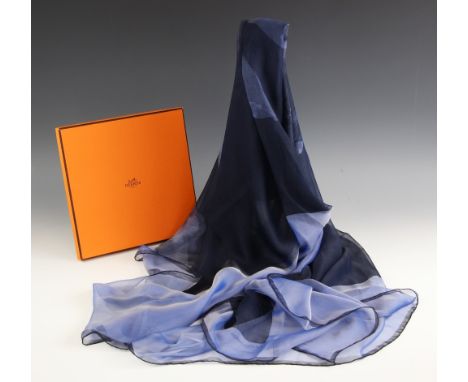 An Hermes fine silk chiffon scarf, designed in blue tones with an figure upon a horse, with rolled hems, 140cm x 140cm, withi