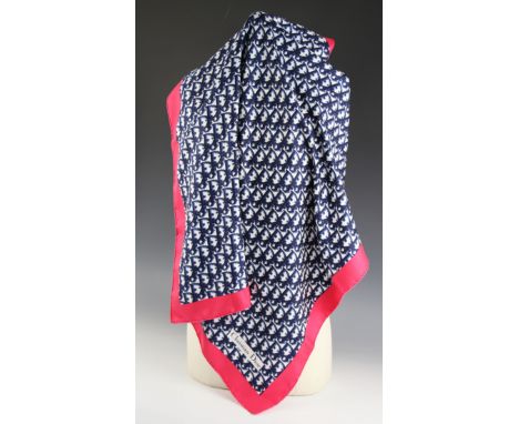 A Christian Dior silk scarf, in navy monogram surrounded by a fuscia pink border, with rolled hem, 77cm x 77cm, unboxedCondit