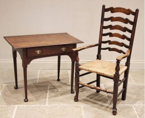 A mid 18th century oak side table, the rectangular moulded top over a single frieze drawer applied with shaped brass back pla