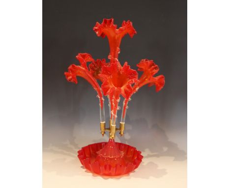 An amber glass epergne of typical form, with central trumpet over four lower trumpets, all with crimped rims, and prunted det