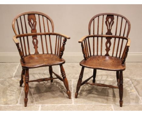 A well matched pair of ash and elm Windsor farmhouse elbow chairs, 19th century, each with a hoop back and central pierced sp