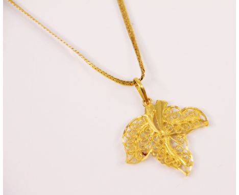 A yellow metal leaf pendant, the stylised ivy leaf pendant with pale polished pendant bale marked '916' 4cm long, upon a asso