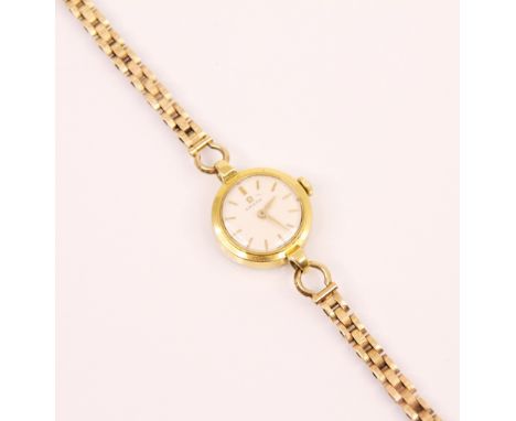 A yellow metal ladies Omega wrist watch, the circular white dial with baton markers, 22mm wide including crown, set to a plai