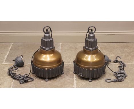 A pair of cast metal industrial type ceiling lights, of bell form with a painted domed shade, enclosed by bare metal gear whe