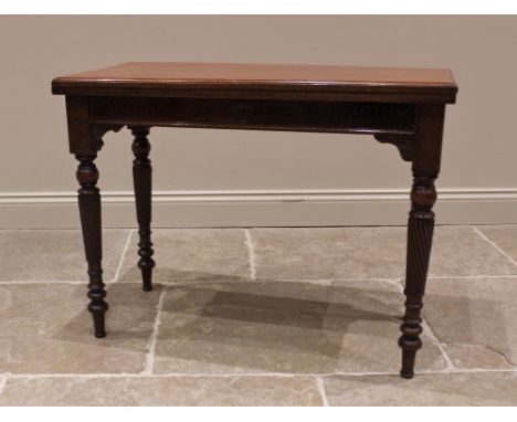 A walnut fold over games table, late 19th/early 20th century, the hinged rectangular moulded top concealing a baize lined pla