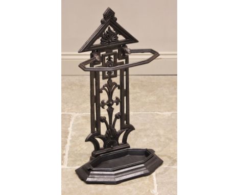 A Victorian cast iron stick stand, of architectural form, the openwork upright extending to a an octagonal stick rail, over t