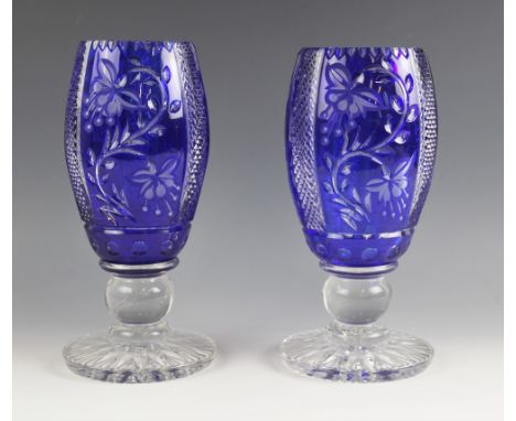 A pair of Bohemian style flashed blue glass vases, 20th century, of ovoid form on on globe knopped stems, the bodies cut with