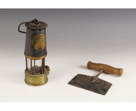 A Victorian brass miners lamp by Protector Lamp &amp; Lighting Co, 'H 9', 23cm high, along with a Victorian herb chopper, wit