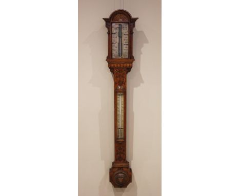 A Victorian carved oak stick barometer, signed Newton & Co, 3 Fleet Street, Temple Bar, London, circa 1870, with a carved lun