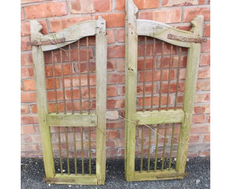 A pair of hardwood and wrought iron gates, applied with iron ring hinges, each gate measures, 106cm H x 40cm W 