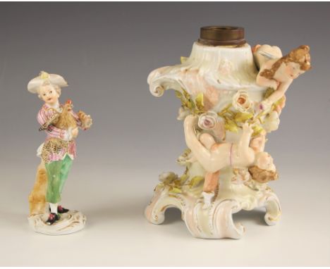 A Meissen porcelain figure of a boy in bicorn hat holding a chicken, set to a scrolled gilt highlighted Rococo base, blue cro