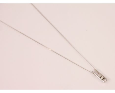 A diamond drop pendant, the three round cut diamonds channel set within two plain polished white metal bars, stamped '375' up