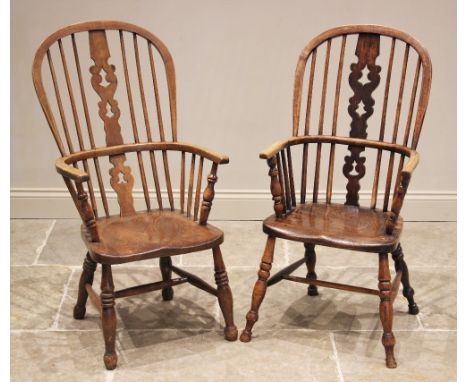 A well matched pair of ash and elm Windsor farmhouse elbow chairs, 19th century, each with a hoop back and central pierced sp