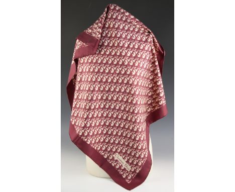 A Christian Dior silk scarf, in maroon monogram, with rolled hem, 77cm x 77cm, along with a further Christian Dior silk scarf