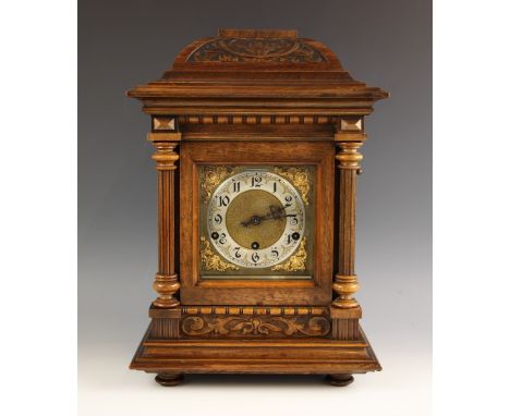 A German walnut cased bracket clock, early 20th century, the architectural case with fluted pillars flanking the 15cm silvere