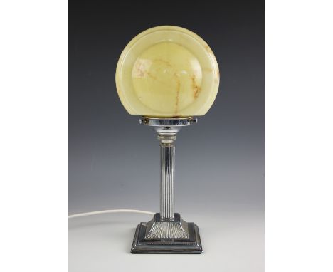 An Art Deco chrome lamp, designed as a fluted column, upon stepped, square platform base and supporting a marbled glass shade