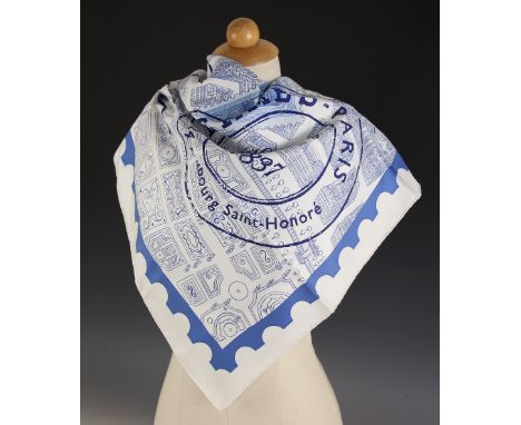 An Hermes silk scarf, in the 'De Passage a Paris' pattern designed by Nathalie Vialars, in blue against a white ground, with 