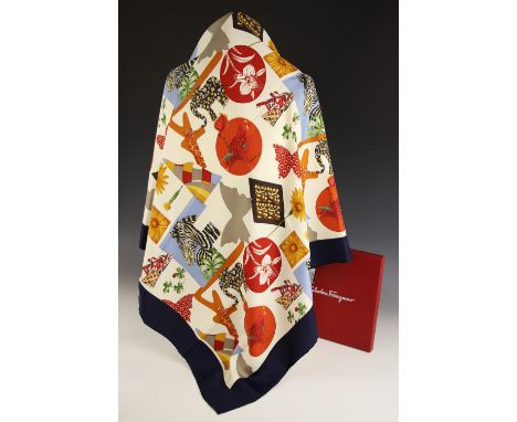 A Salvatore Ferragamo silk scarf, decorated in an abstract design depicting flora and fauna, within a navy blue border, with 