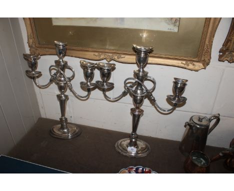 A pair of antique plate on copper three light candelabras