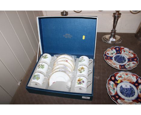 A boxed set of six Royal Worcester Botanic decorated coffee cans and saucers 