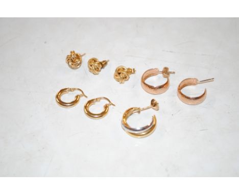 A pair of 9ct gold hoop earring, 1gm total weight; two pairs of yellow metal earrings, 3gms total weight; and two single 9ct 