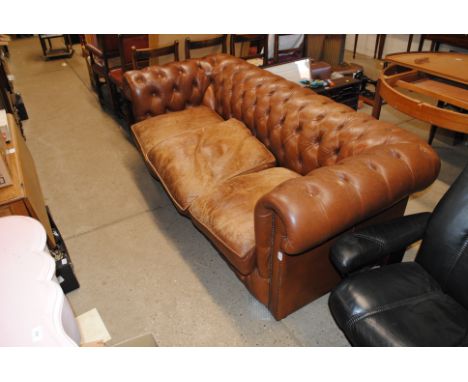 A leather upholstered deep buttoned Chesterfield sofa