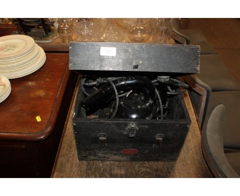 A WWII Royal Navy signalling lamp in wooden case