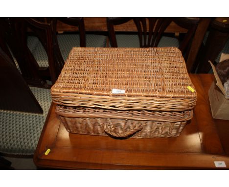 A wicker picnic hamper and contents of various turned wooden bowls etc.